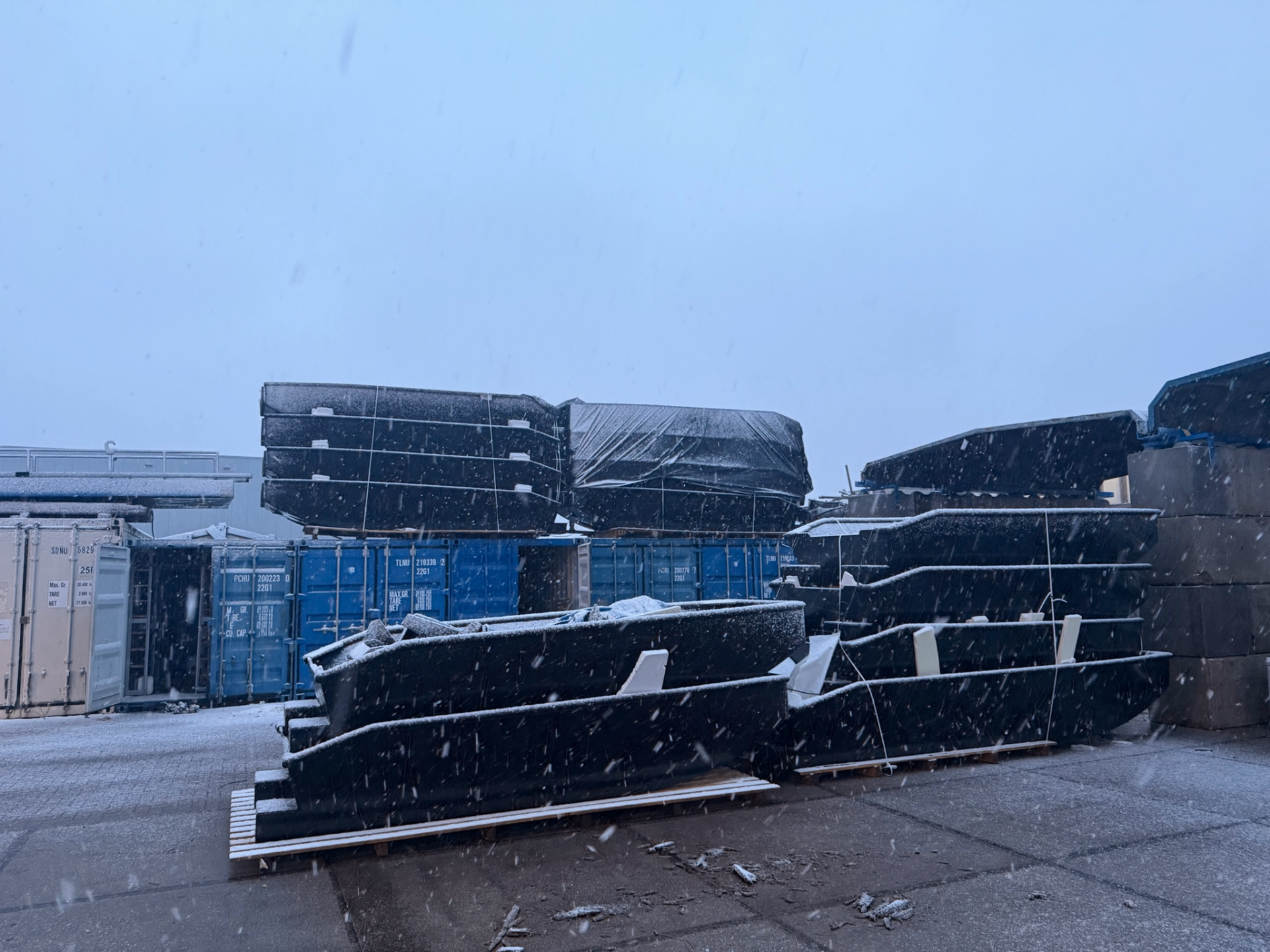 Stacked Black Workboats in snow